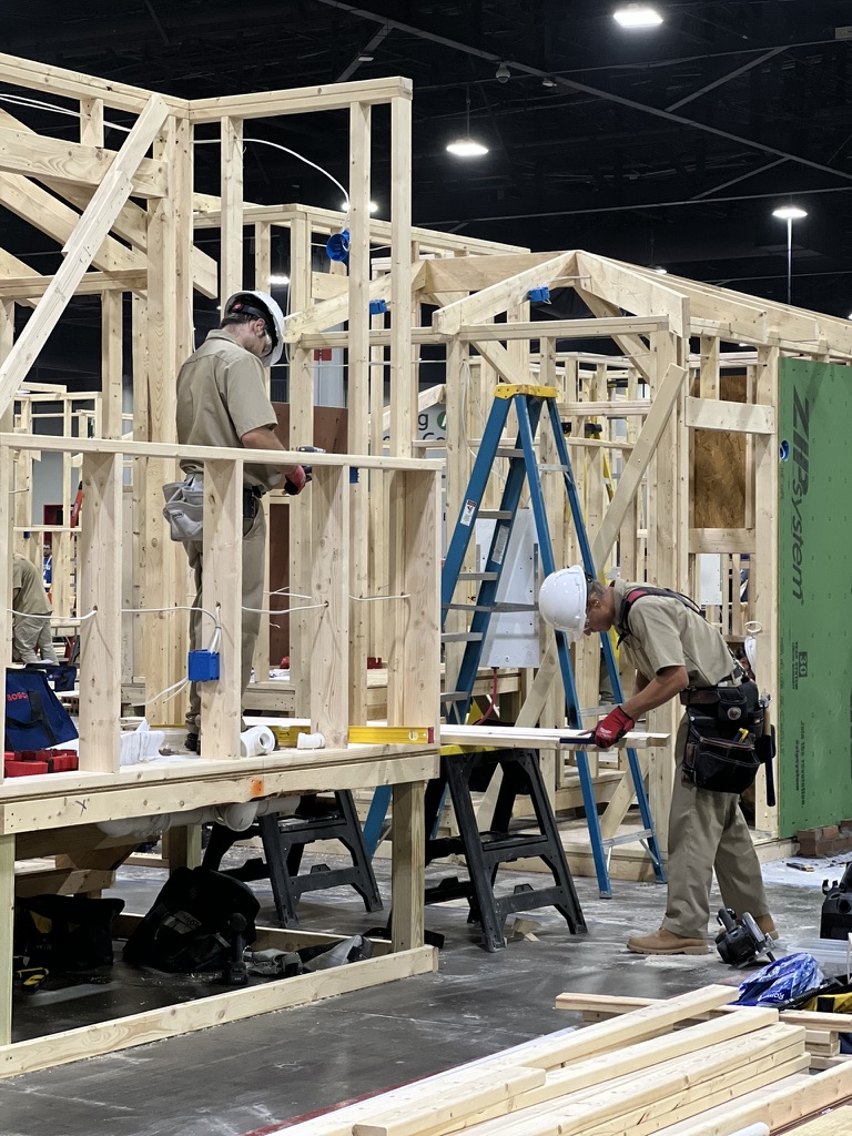Students applying construction skills in a hands-on national competition